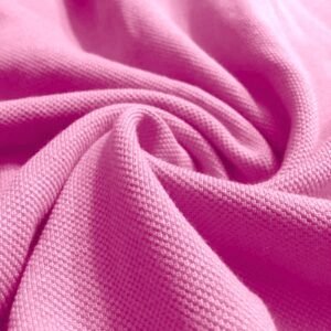 Close-up of pink Lacoste fabric used for polo t-shirts in Malaysia
