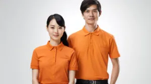 Male and female staff wearing orange polo t-shirt uniforms in Malaysia