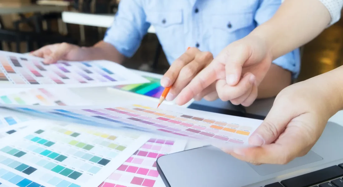 Graphic design and color swatches and pens on a desk. Architectural drawing with work tools and accessories.